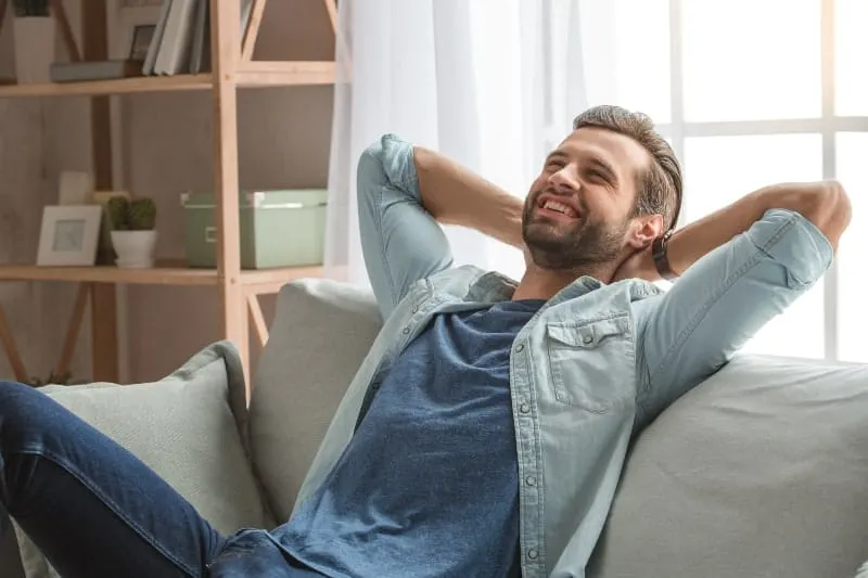 Happy guy sitting on couch