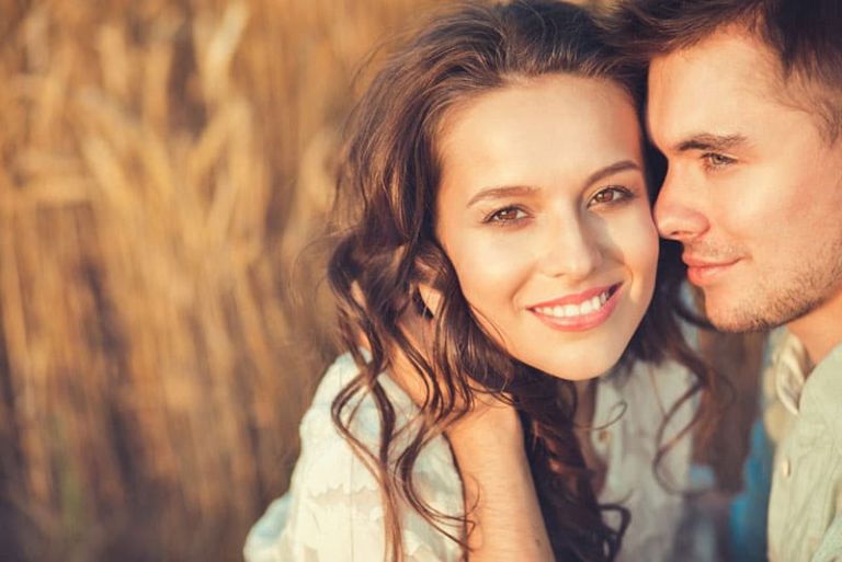 happy couple sitting in sunlight