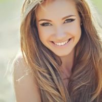 a woman with long blonde hair laughs