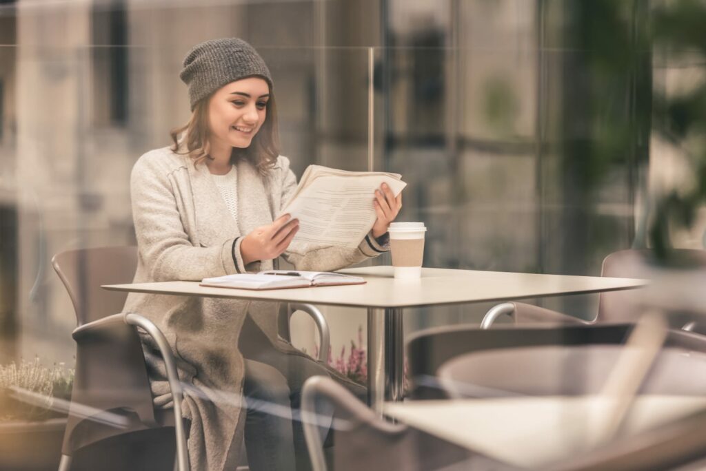 a girl reading a newspaper