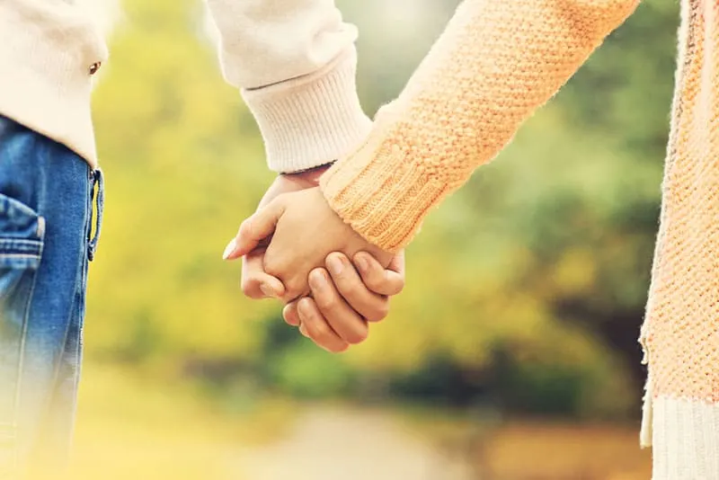 couple holding hands tight