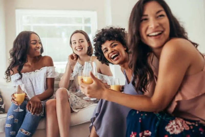 group of female friends smiling at home