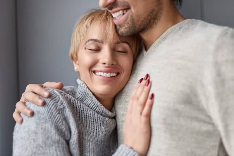 happy woman leaning on man chest