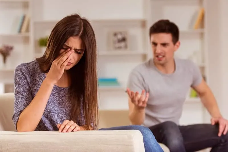 man arguing with crying woman