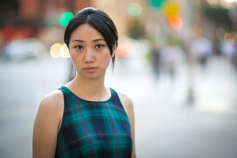 Young Asian woman in New York City street serious face portrait
