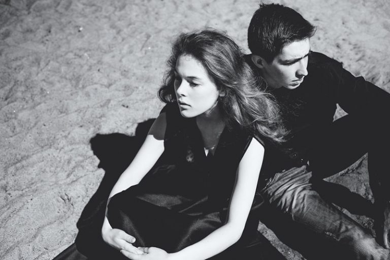 Beautiful couple. young girl and a man sitting facing away from each other