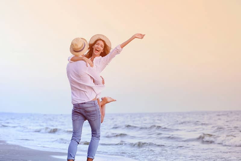 Young happy couple on seashore