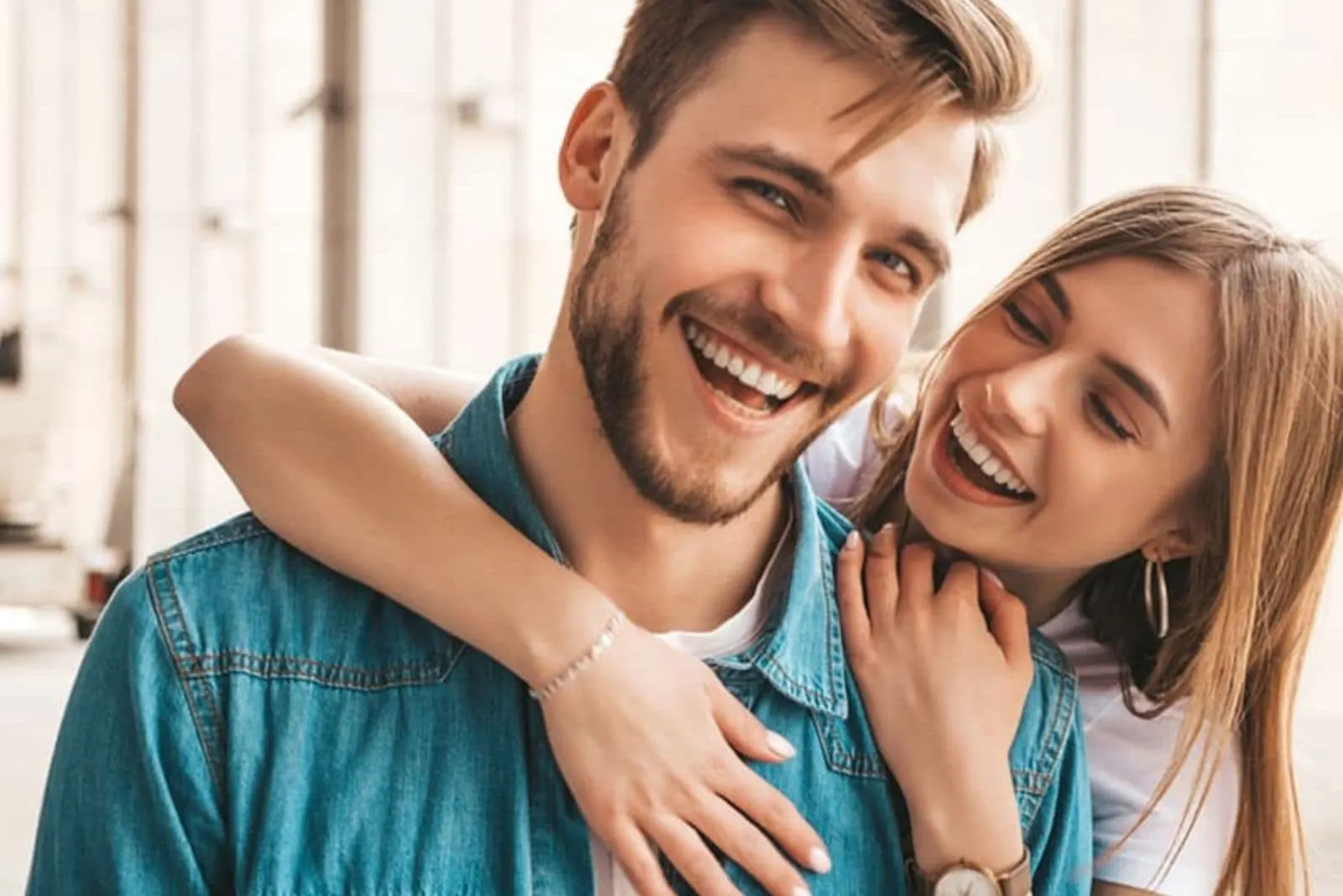 the woman hugs the man and laughs