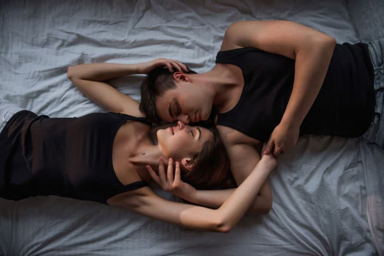the man and woman lie embraced