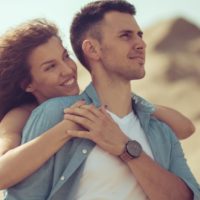 lovely couple hugging and enjoying the walk in the nature