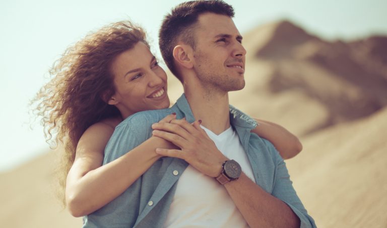 lovely couple hugging and enjoying the walk in the nature