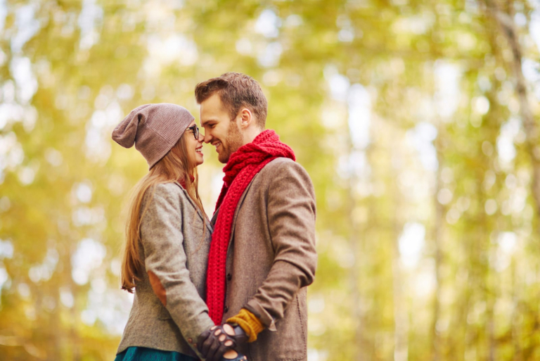 romantic couple standing in the wood