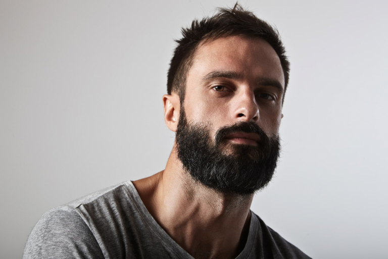 Close-up portrait of a brutal bearded man
