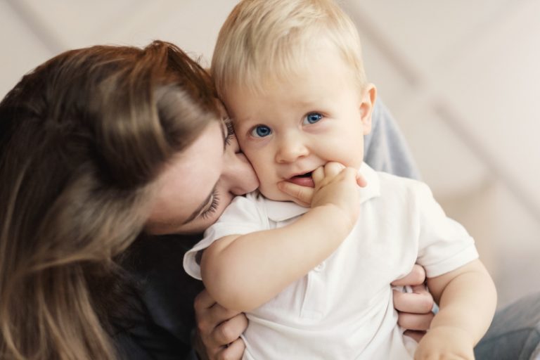 mom kissing her baby