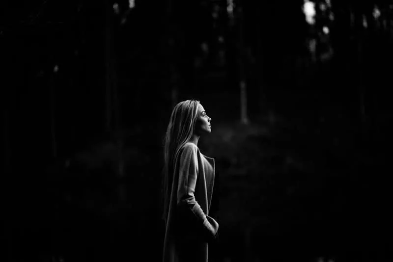 black and white portrait of a blonde woman in the woods