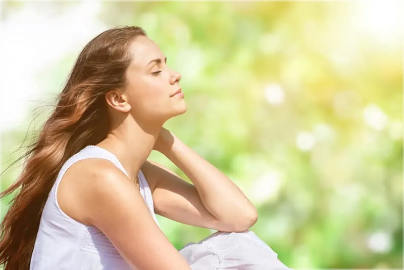 calm young woman meditates outdoor