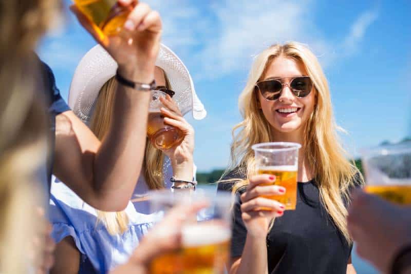 group of female friends drinking beer outside