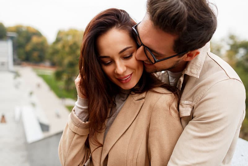 happy young couple outdoors hugging