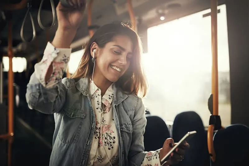 happy coung latino girl smiling on the bus