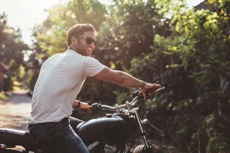 man with sunglasses on motorbike
