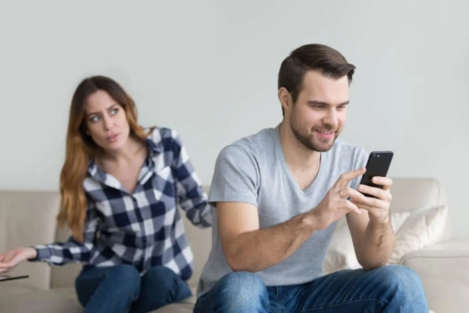 nervous woman while man holding phone