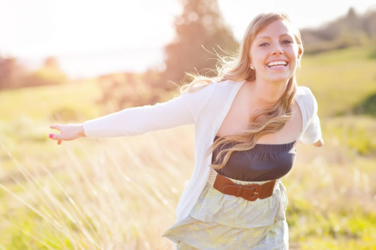cheerful happy woman in field