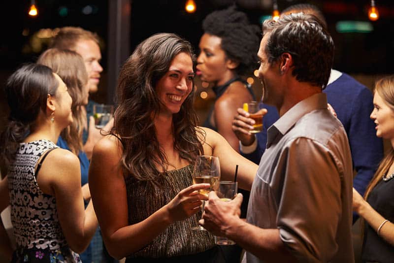 smiling man and woman talking at bar