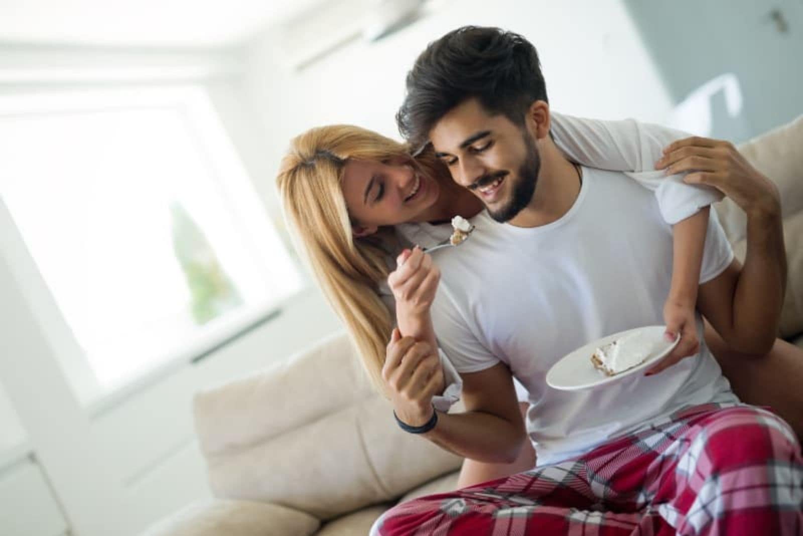 woman giving breakfast to her man in pijama