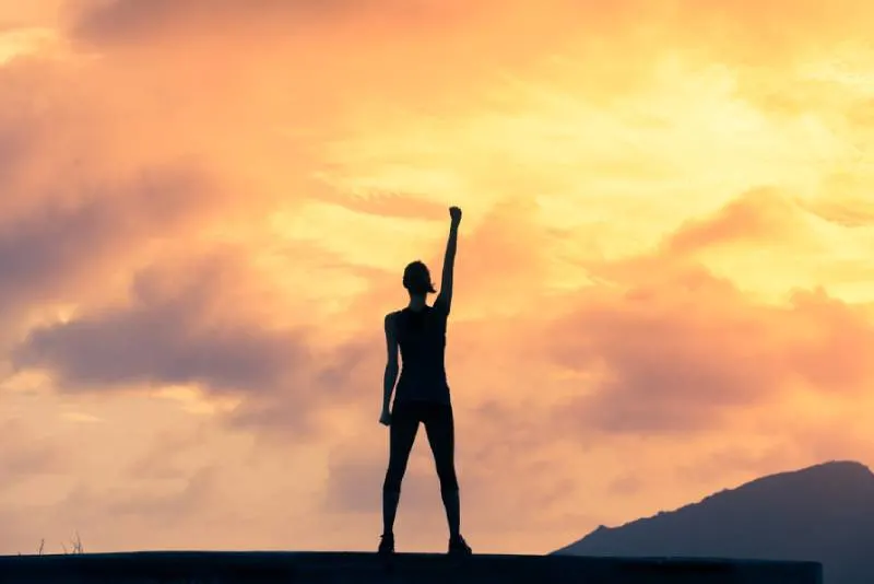 woman with hand up strong