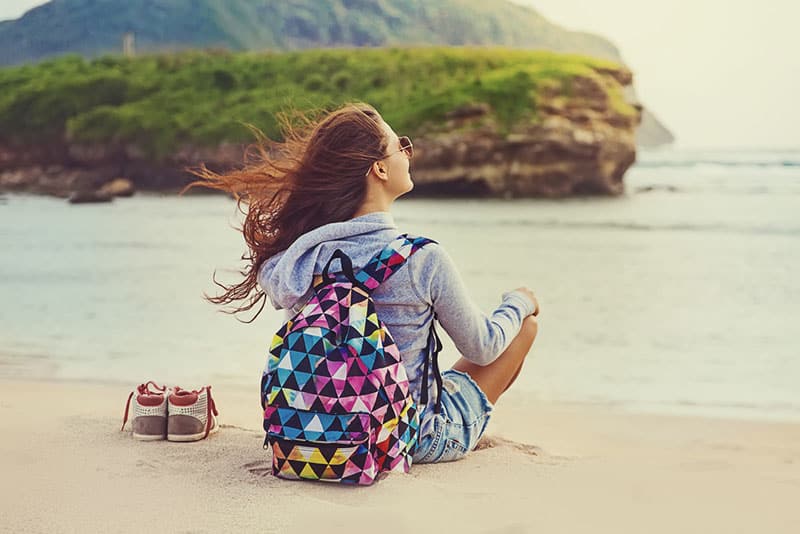 young woman sitting on beach