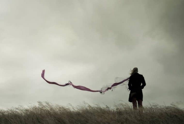 silhouette of woman standing alone in nature