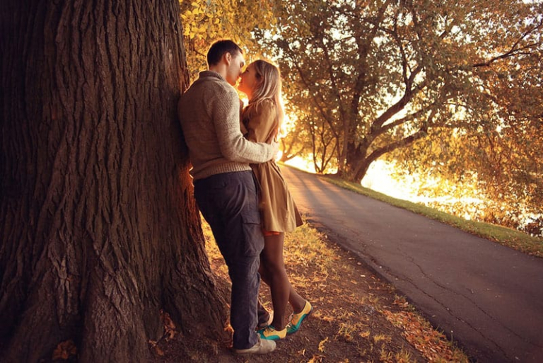 happy couple kissing in sunset