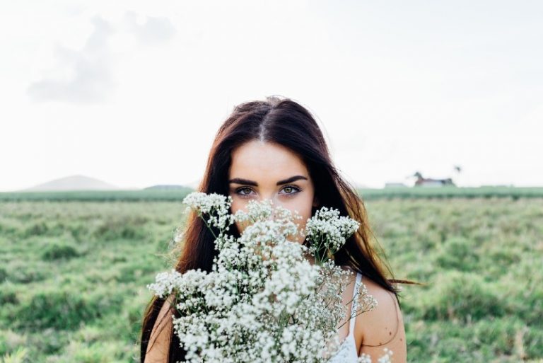 Woman holding white flowers outdoor