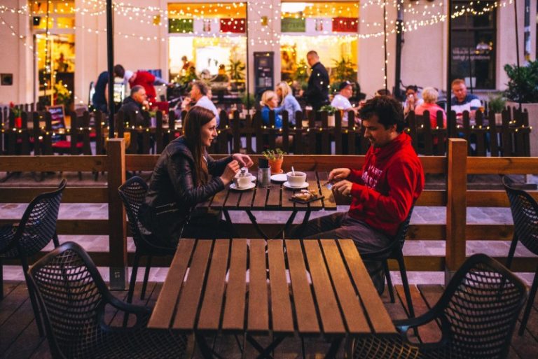 woman and man sitting at table outdoor