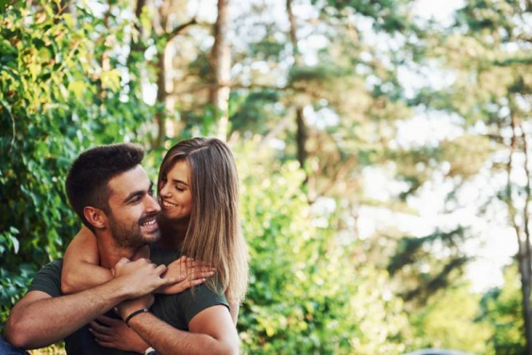 happy couple hugging in nature