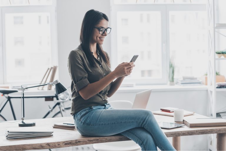 smiling woman typing on her phone