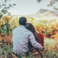 couple hugging and sitting in nature