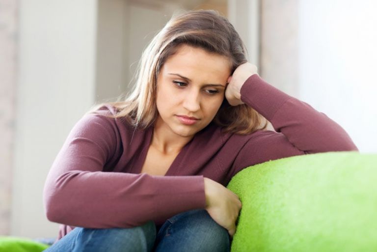 sad woman thinking on the couch