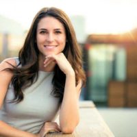 portrait of happy woman smiling outside