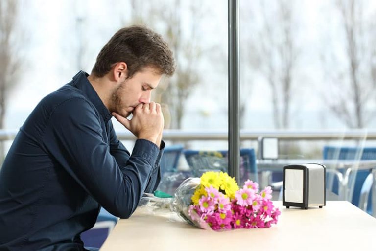 sad man sitting in cafe