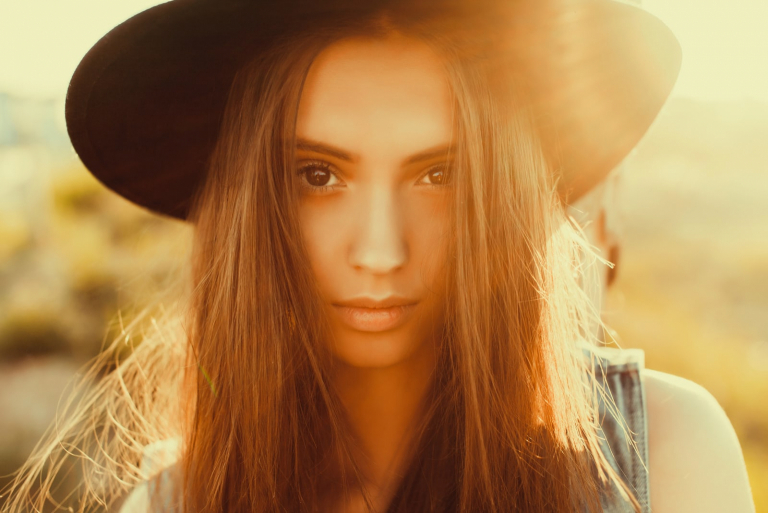 beautiful young woman with hat posing