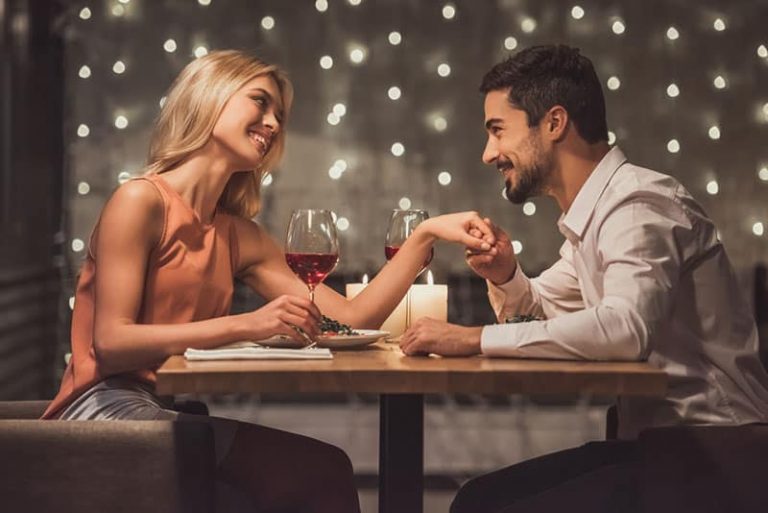 happy man compliments woman on the dinner date