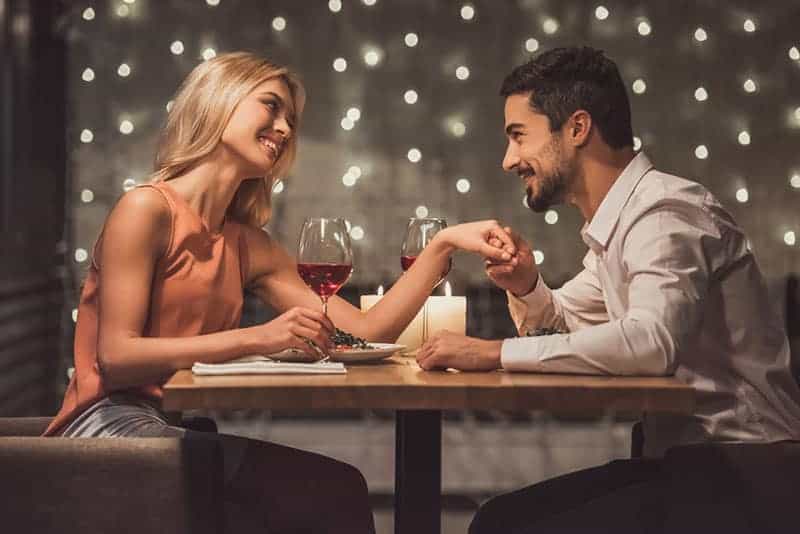 happy man compliments woman on the dinner date