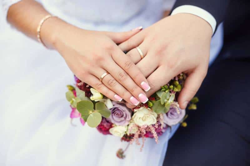 marriage couple holding hands with rings