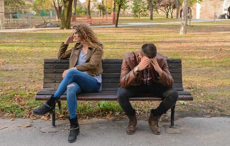 Couple Woman and Man quarrel while sitting on bench