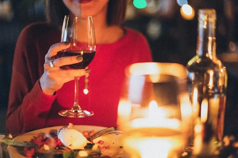 Woman holding wine glass dinner date