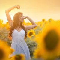 happy girl in sunflower field