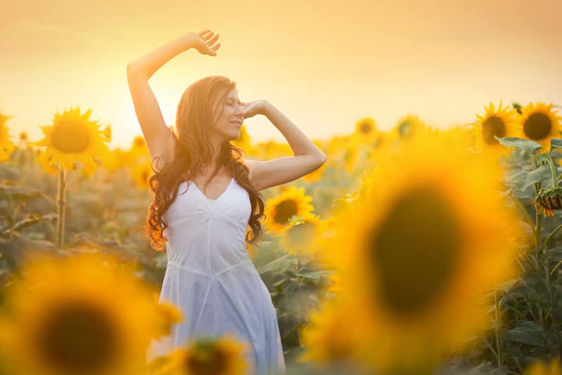 happy girl in sunflower field