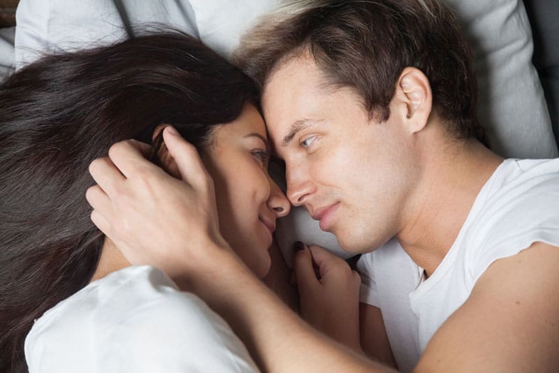 happy couple talking in the bed