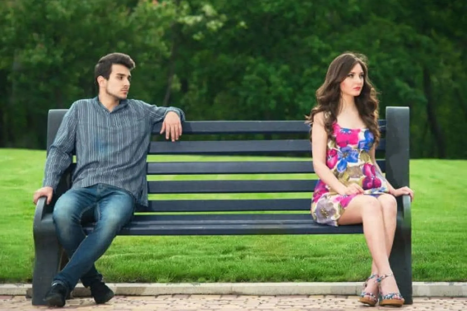 a man and a woman sitting on a bench